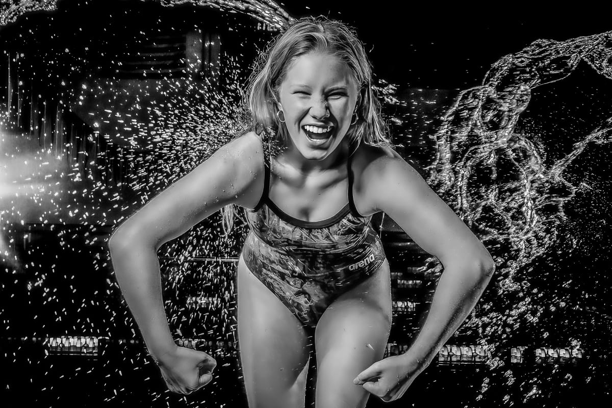 Black-and-white action portrait of a swimmer with a water splash